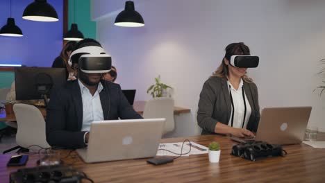 business people wearing virtual reality glasses while working in modern creative space