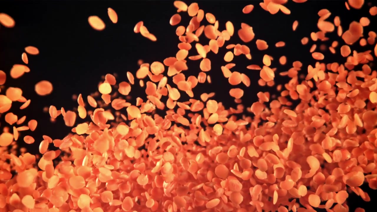 Delicate Orange Petals Floating Up and Down on a Dark Background