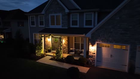 Large-American-home-decorated-with-Christmas-lights-and-garland