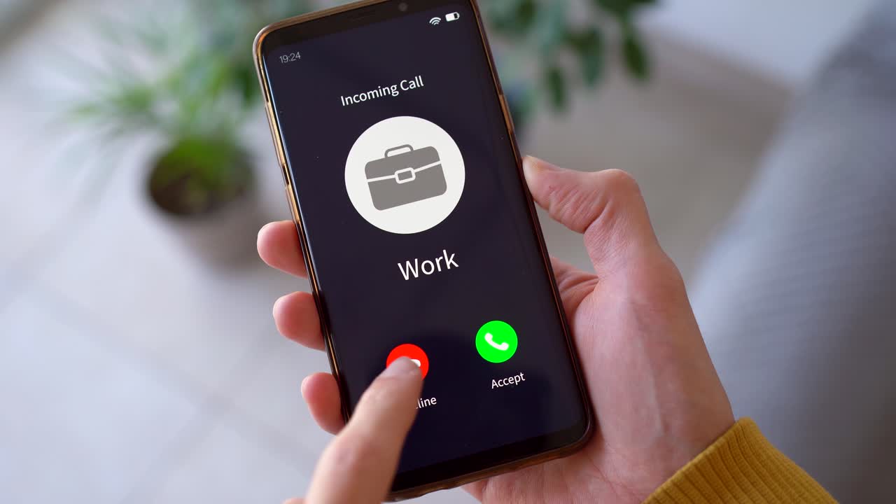 Incoming Call From Work - Person Hesitating Whether To Answer The Call From Work. - closeup shot