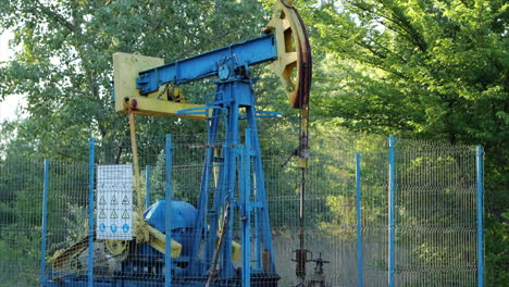 static view of oil pumpjack pumping crude oil in campina, romania