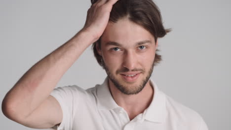 Caucasian-man-in-front-of-camera-on-gray-background.