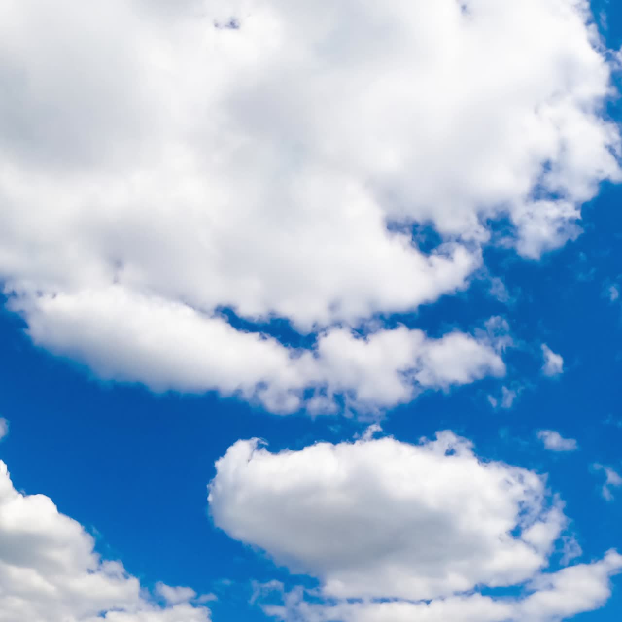Quick transformation of white clouds in the atmosphere. Fluffy cloudscape growing in the sky. Timelapse
