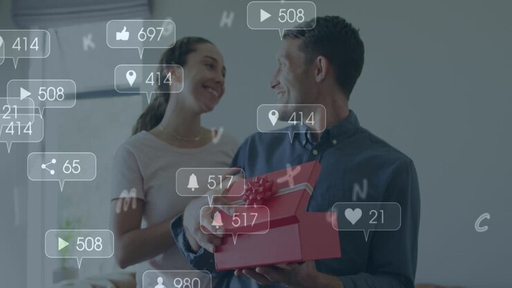 Animation of social media icons over caucasian man opening a box gifted by his home at home