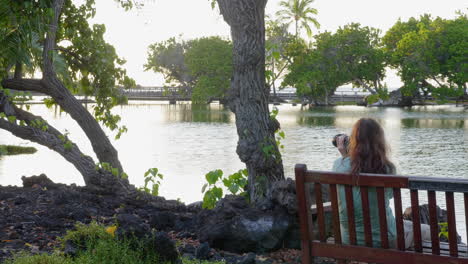 woman photographer at mauna lani fish ponds, hawaii