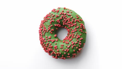 closeup sweet delicious donut with green glaze and pink pastry topping. shot with red camera in 4k