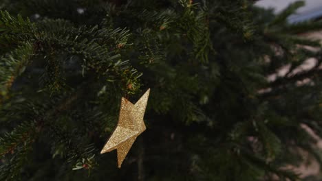 hanging golden star on green christmas tree 4k