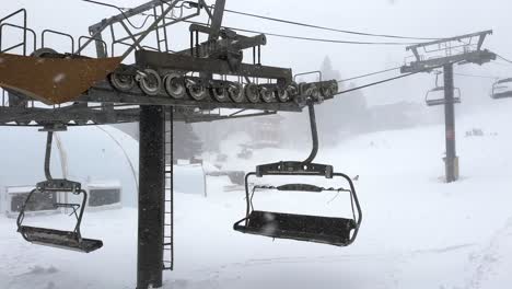 ski chairlift machinery operating in intense mountain blizzard snowstorm