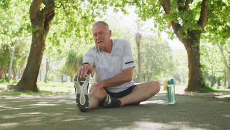 Senior-man-stretching-his-legs-in-the-park