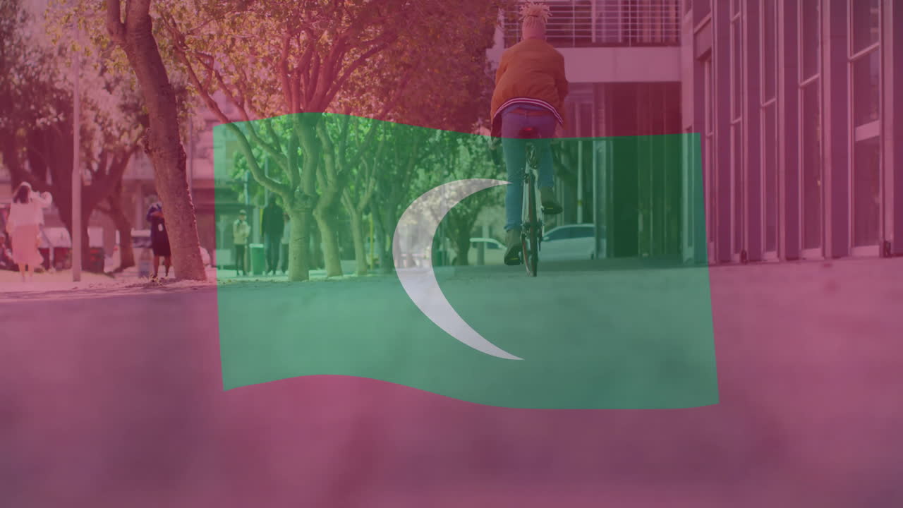 Riding bicycle on street, person with animation of Maldivian flag overlay