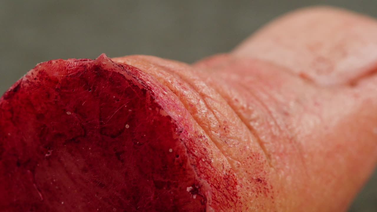 A rubber fake finger with blood close-up. Make-up equipment props for films and shooting. Bloody fake fingers for halloween and parties