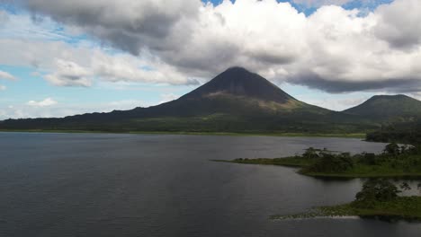 drone flying forwards to iconic arenal volcano in costa rica