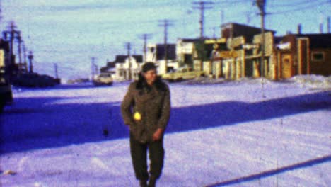1957: hombre del distrito comercial del centro caminando rápido en el frío invierno.
