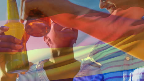 Composite-video-of-waving-germany-flag-over-group-of-diverse-friends-toasting-beers-outdoors