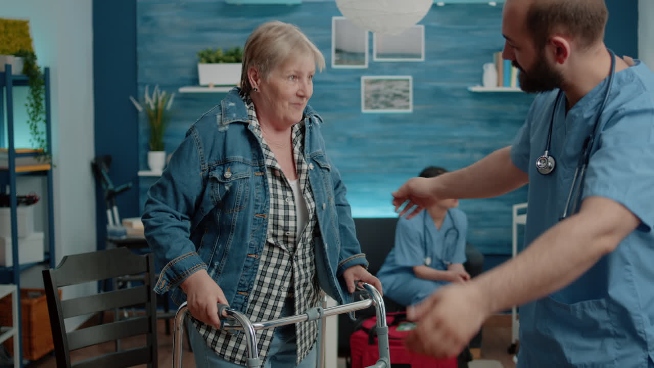 Invalid woman getting dressed with jacket while nurse helping