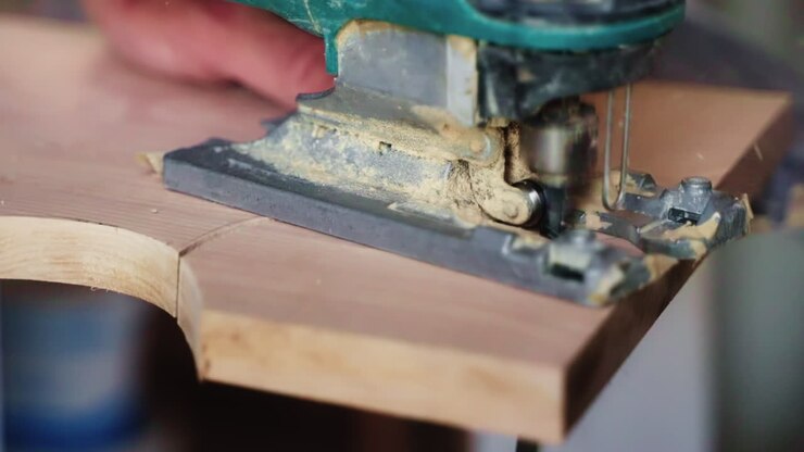 Person Using Jigsaw to Cut Wood