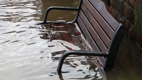 Der-Fluss-Severn-Ist-überschwemmt-Und-Wasser-Bedeckt-Eine-Bank-An-Seinen-Ufern-In-Bewdley,-Worcestershire