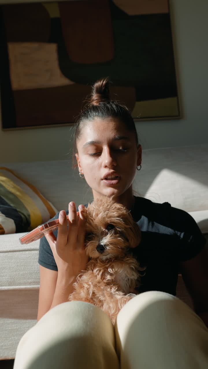 Young Woman Talking While Holding Her Cute Dog at Home