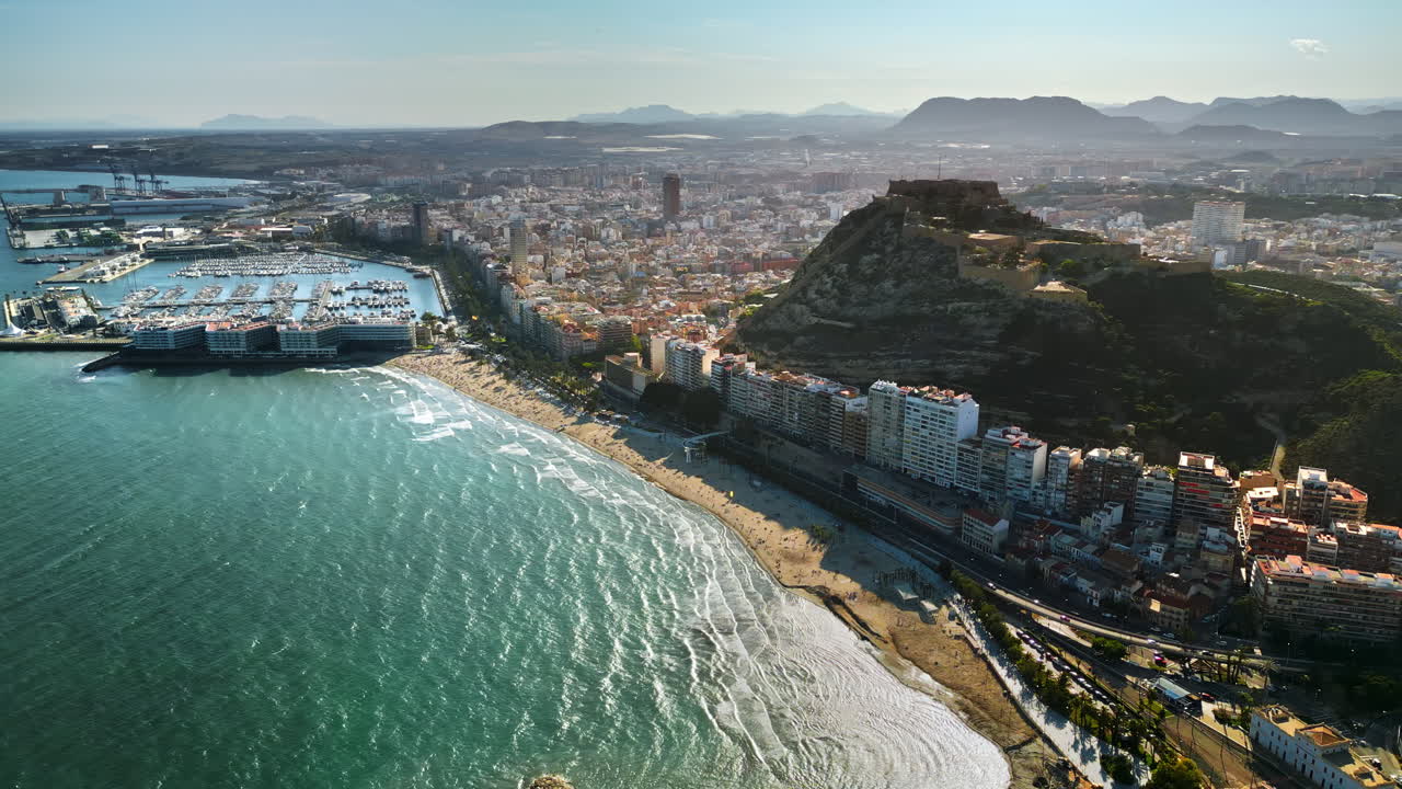 İspanya, Alicante kıyısındaki Santa Barbara Kalesi'nin gündüz şehir ve deniz manzaralı drone görüntüsü