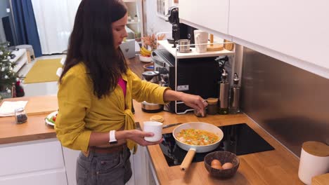 mujer cocinando verduras en una cocina