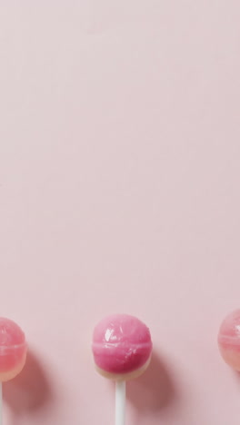 video of pink lollipops on pink background