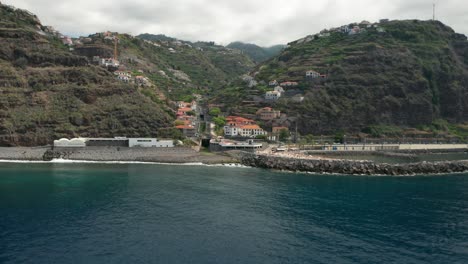 aerial of coastal village calheta on rugged volcanic island madeira