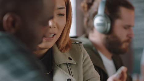 beautiful asian woman chatting to friend in cafe showing smartphone social media messages best friends hanging out sharing gossip enjoying connection