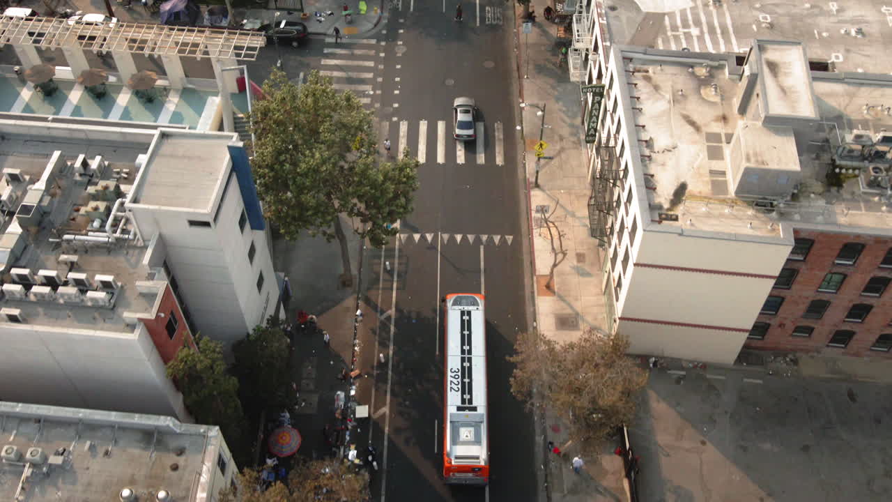 Aerial View of an Urban Street with Traffic and Pedestrians