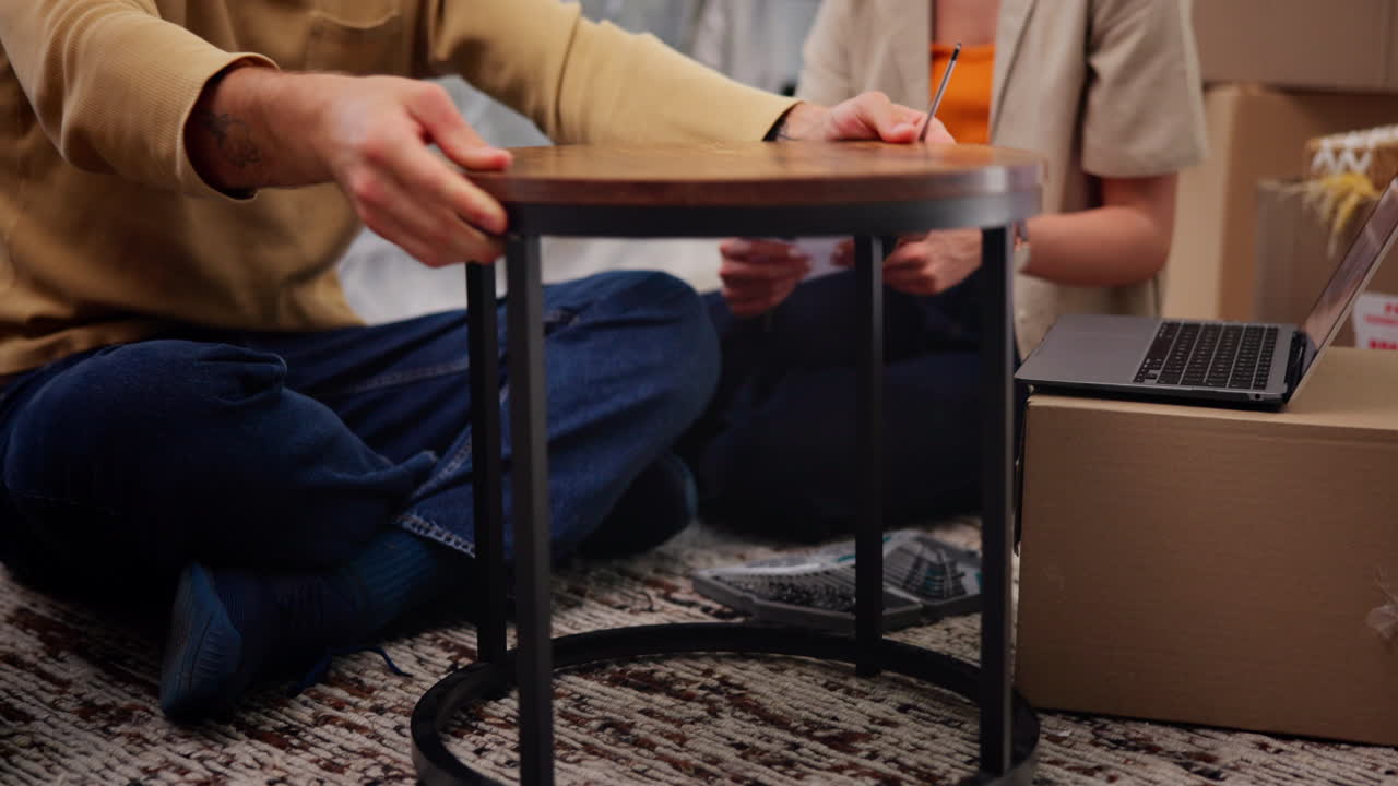 Couple Assembling New Furniture Together in Their New Home