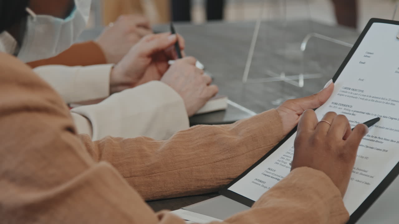 HR Looking at Application Form During Job Interview