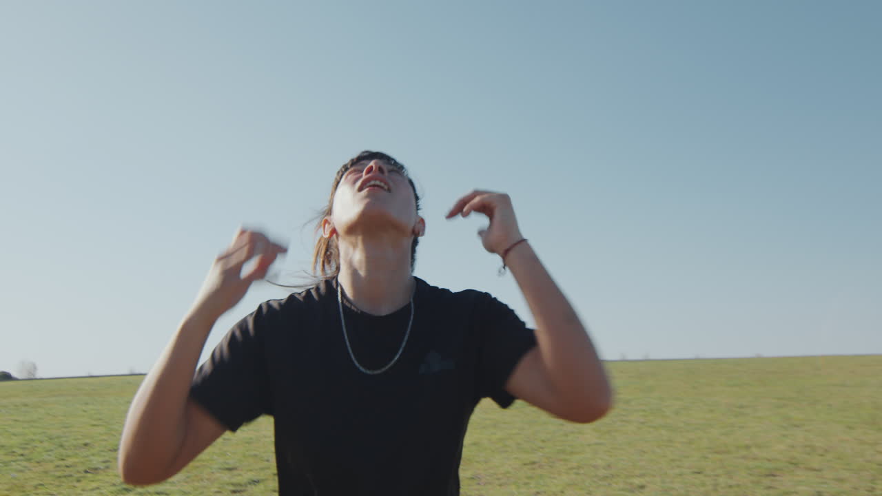 Girl Juggling Soccer Ball with Head Outdoors