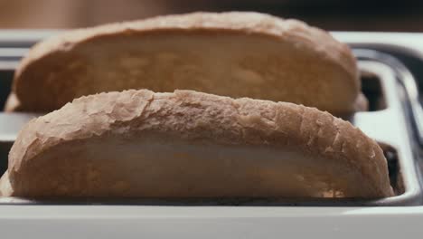 close-up of bread slices being toasted in kitchen toaster