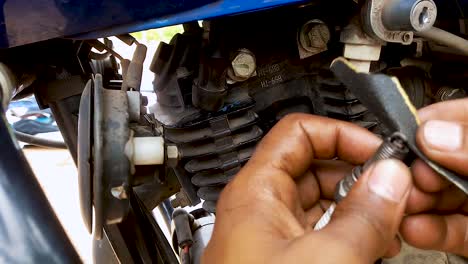 two-wheeler-motorbike-maintenance-at-day-from-flat-angle-in-details