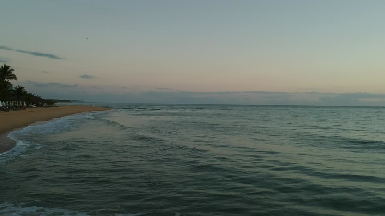 Beach waves at sunrise.