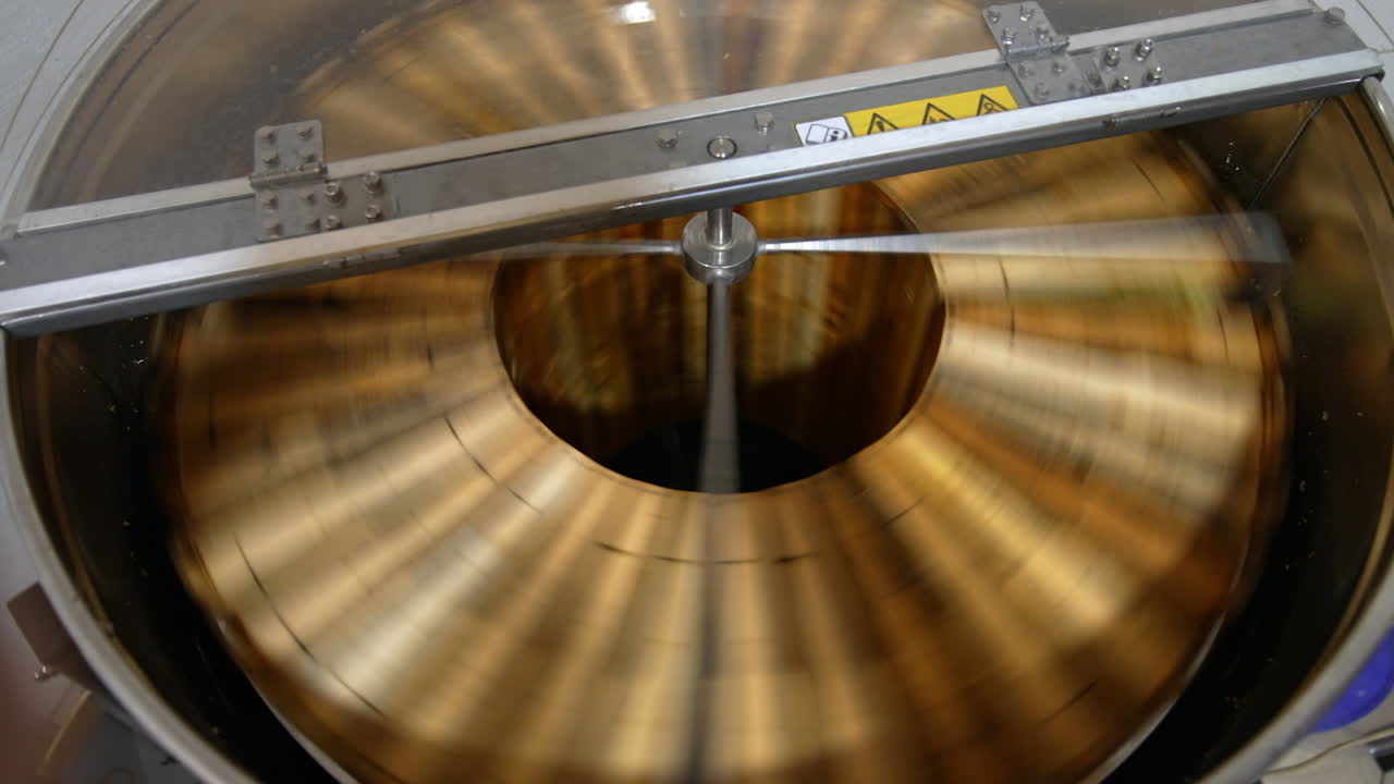 Honey frames rotating inside the machine. Electric equipment for pumping honey at apiary. View from top.