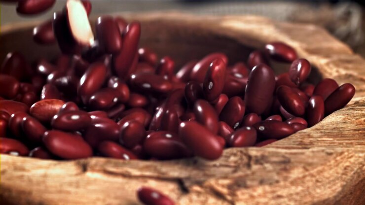 Red Kidney Beans Falling into a Rustic Wooden Bowl in Slow Motion