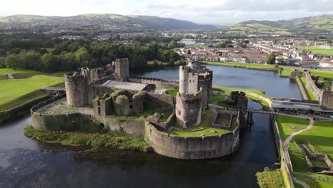 birds fly by picturesque caerphilly castle in wales aerial view