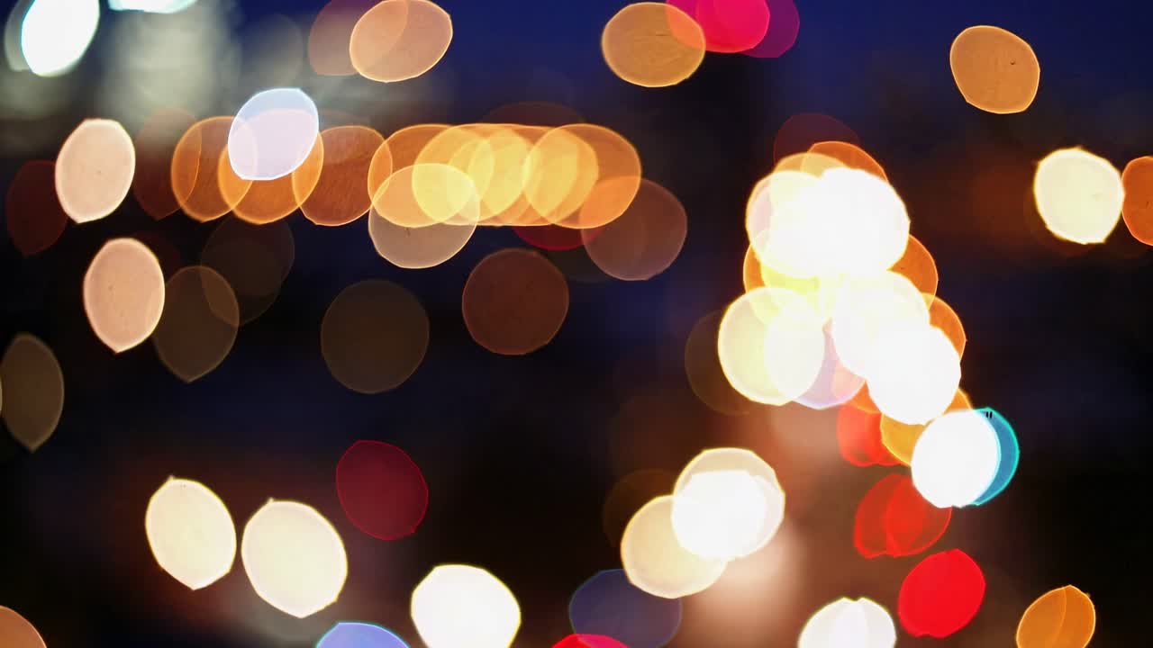 Abstract bokeh video style with blurred city lights. Shot from a high angle, capturing vibrant