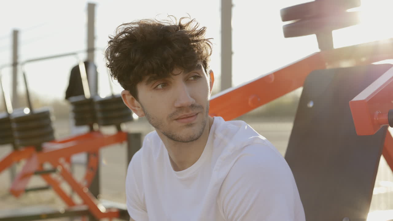 Man Relaxing Outdoors at a Gym