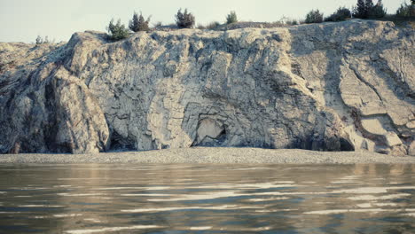 a rocky cliff overlooking a calm body of water