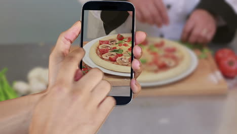 hand showing cooking clips on smartphone