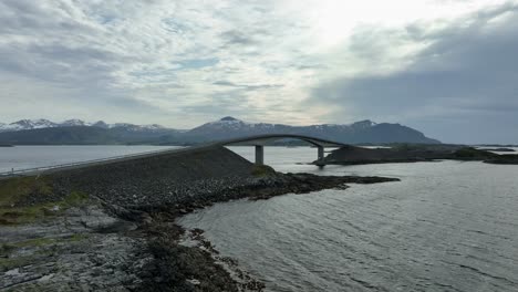 storseisundet bridge - slow evening aerial presenting the bridge with a slow combined sideways move and orbit - atlantic ocean road norway