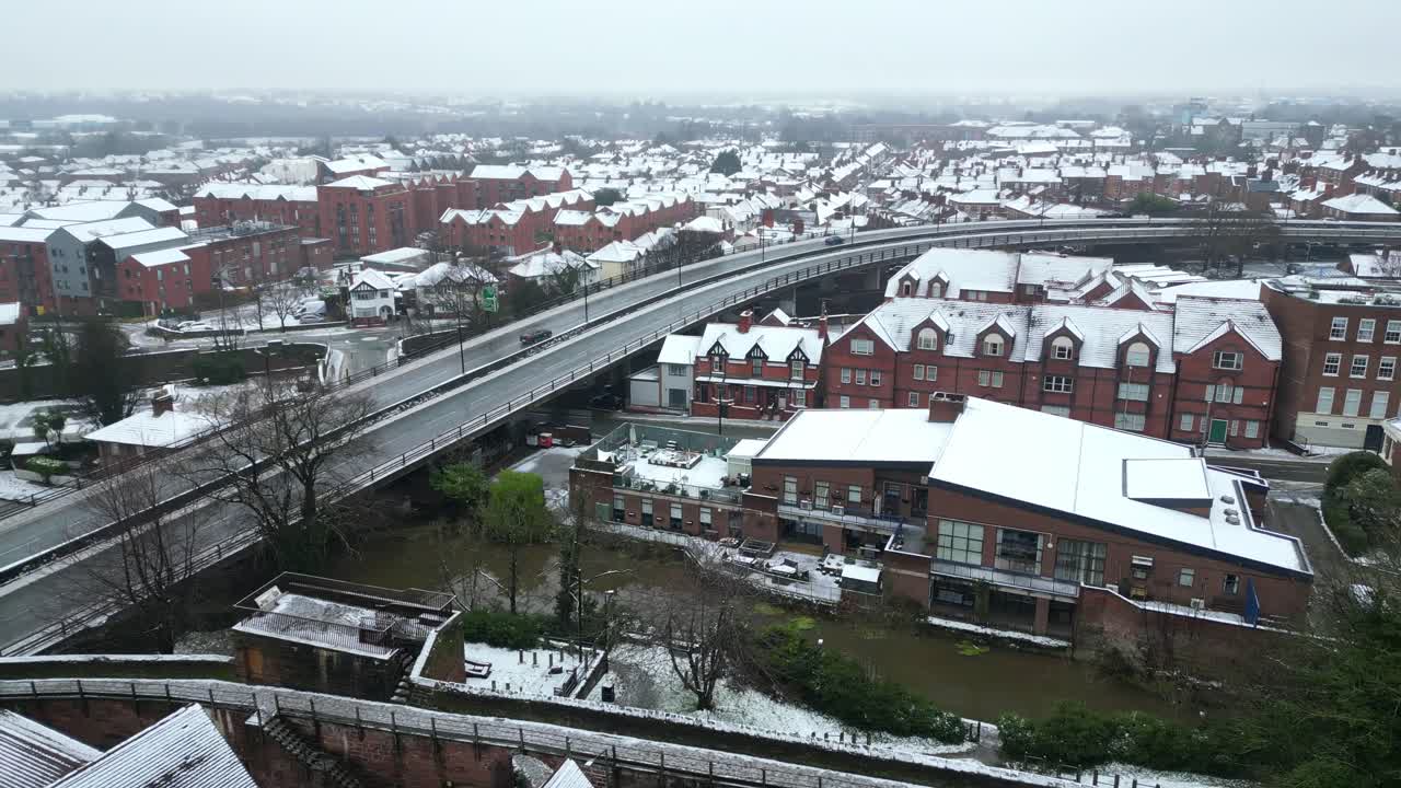 Aerial view of Chester on a cold, overcast day, with snow-covered streets and rooftops under a gray, misty sky.