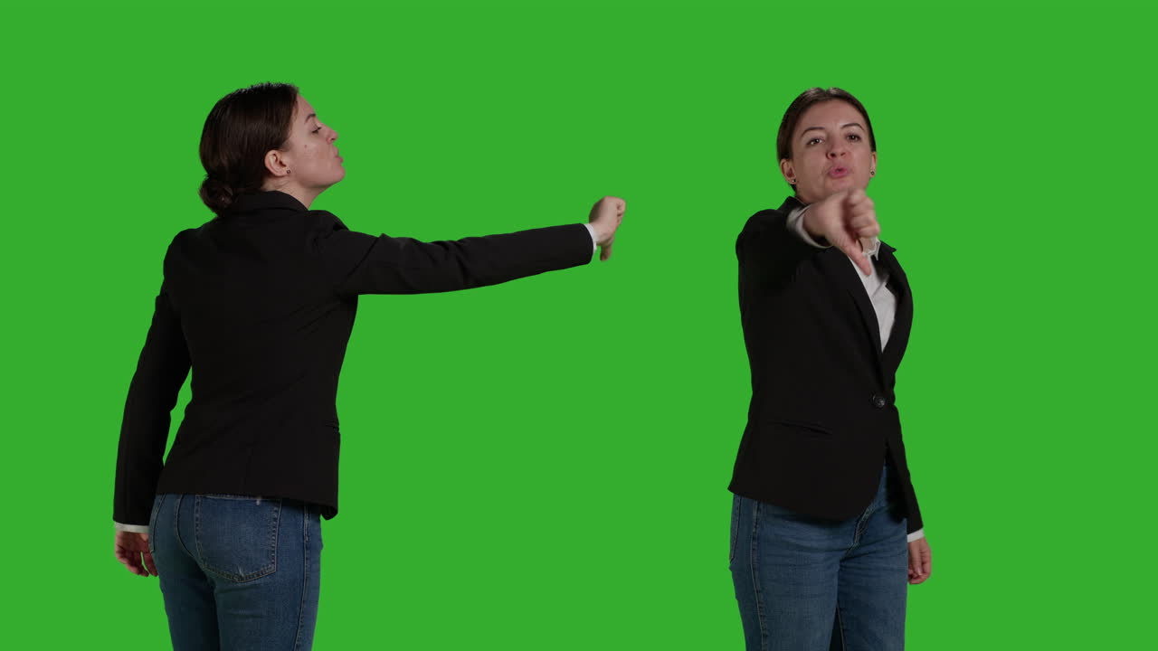 Businesswoman giving thumbs down on green screen
