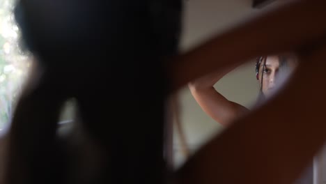 woman getting ready in front of a mirror