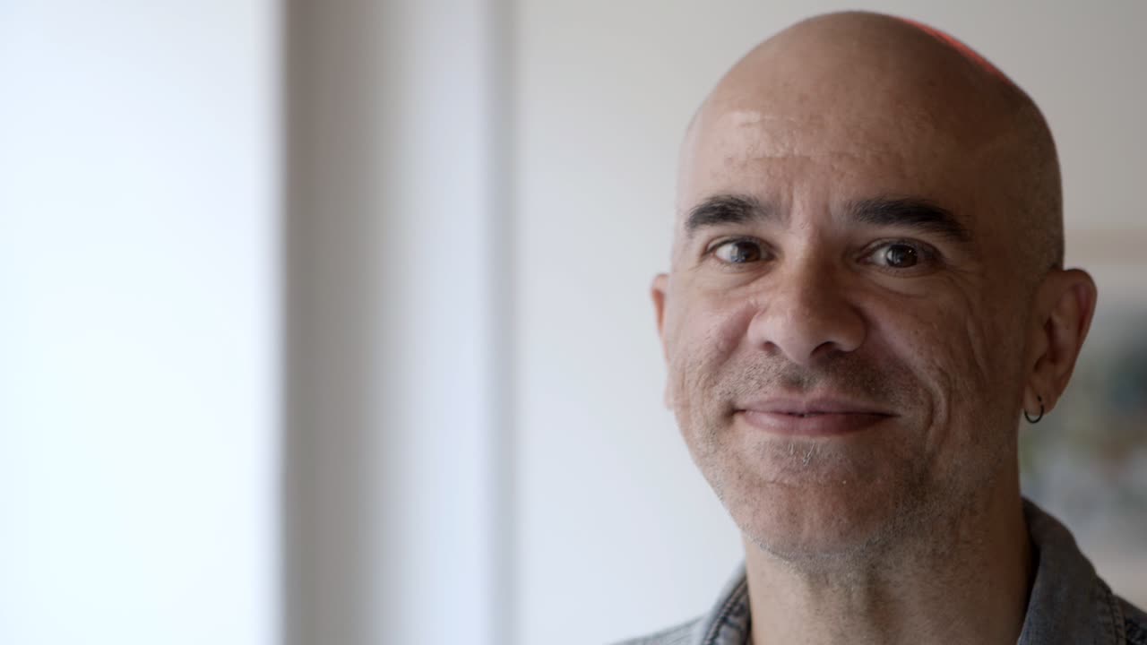 Handsome serious bald man posing