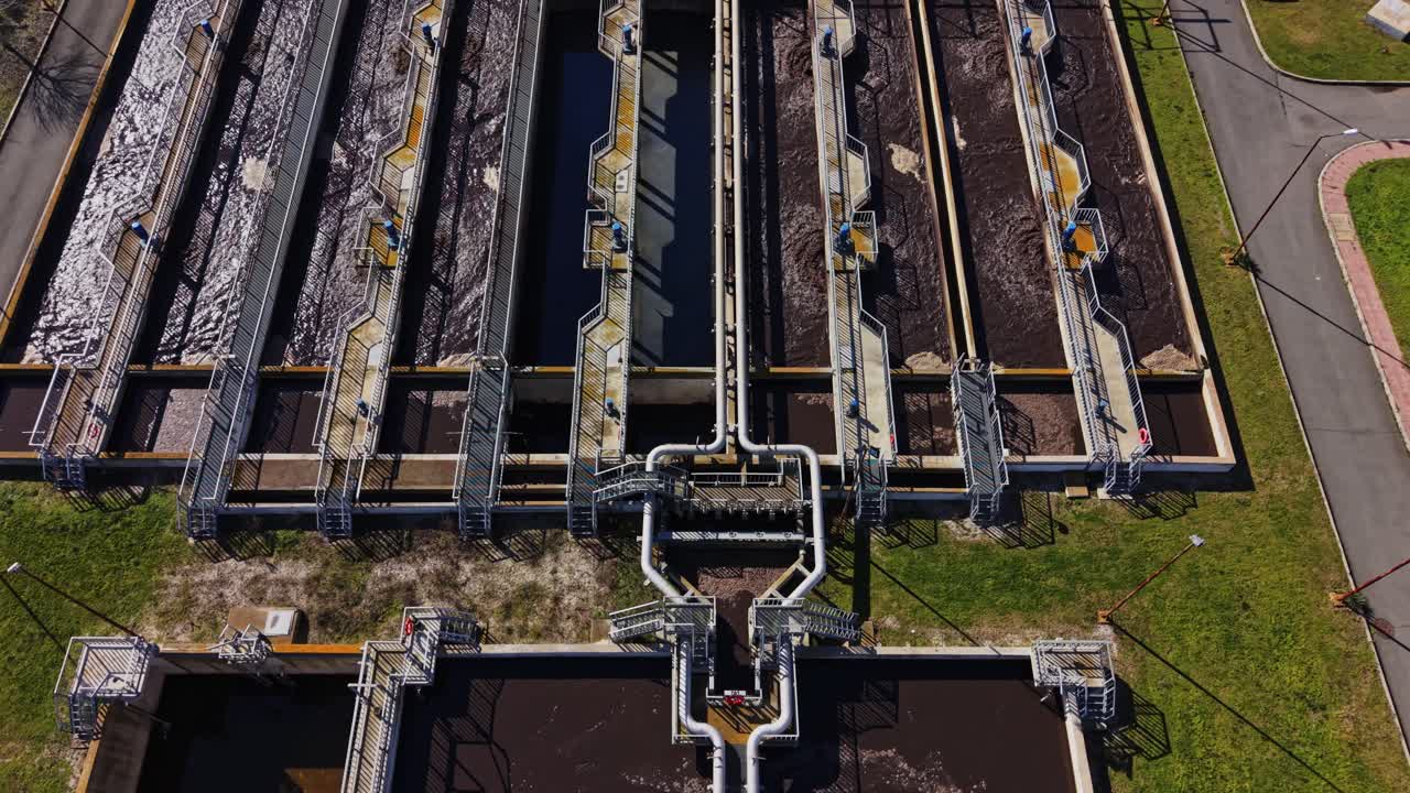 Water treatment facility shows tanks and pipes at work in the city