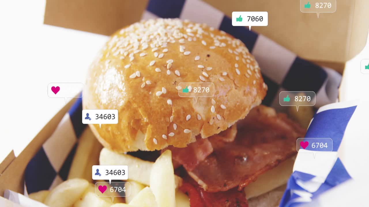 sesame-seed burger and fries sitting in to-go box while social tags appearing, multiplying for ads