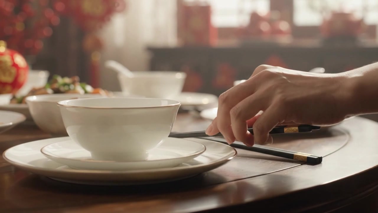 Person Placing Chopsticks on a Table Setting