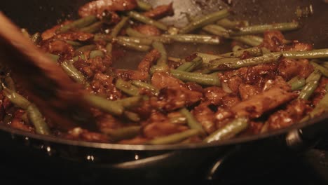 vegan pork teriyaki dish being stirred by chef